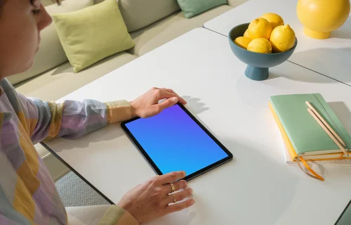 iPad Air Mockup in a Woman's Hand in a Bright Living Room