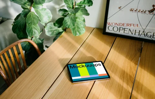 iPad Air mockup on a dining table in front of a framed photo 