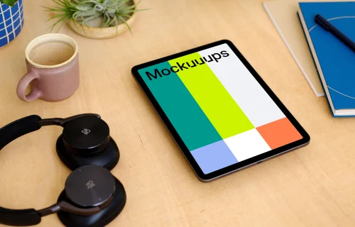  iPad Air mockup with a pair of headphones at the side