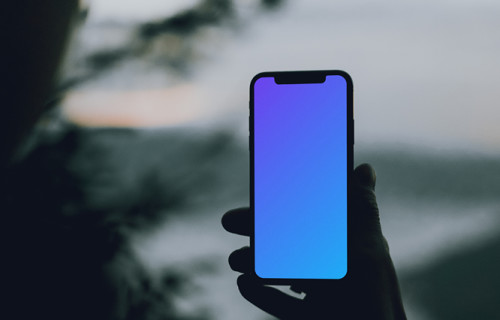 iPhone 12 Pro mockup held by a user