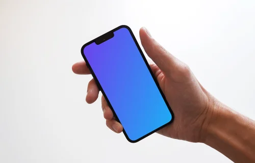 iPhone 13 mockup held by user against plain white surface