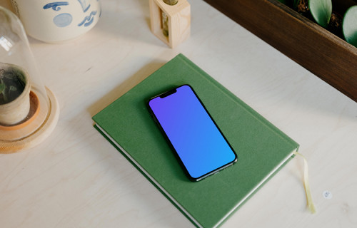 iPhone 13 Pro on a green notepad