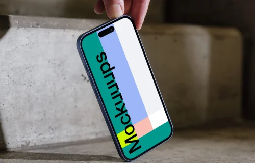 iPhone 16 mockup held on concrete stairs