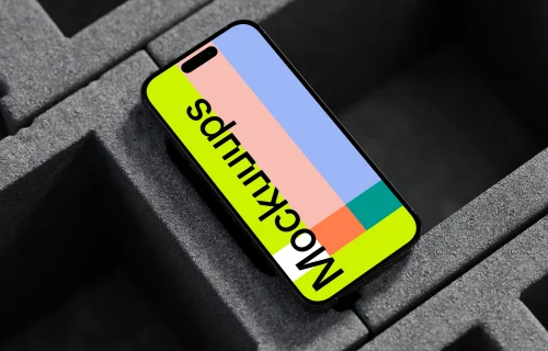 iPhone 16 mockup laying on concrete blocks