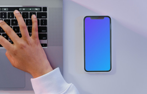 iPhone mockup beside grey MacBook