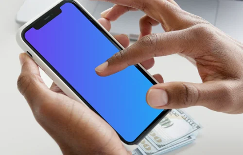 iPhone mockup in user’s hand with a MacBook