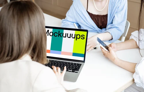 Lady typing on a MacBook Pro mockup in a meeting