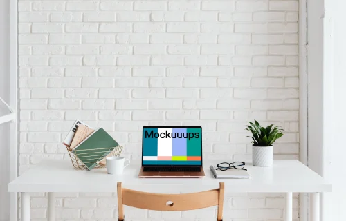 MacBook Air mockup beside a basket of books