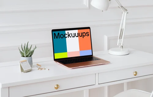 MacBook Air mockup on a desk beside a potted plant