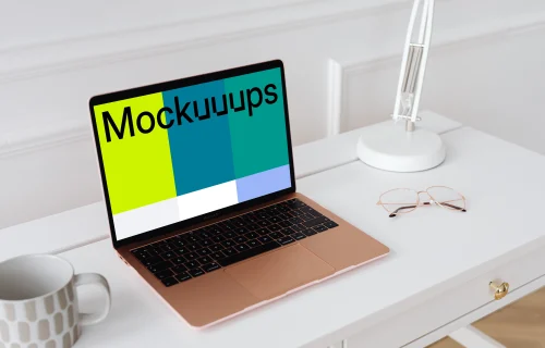 MacBook Air mockup on a table with a coffee mug at the side