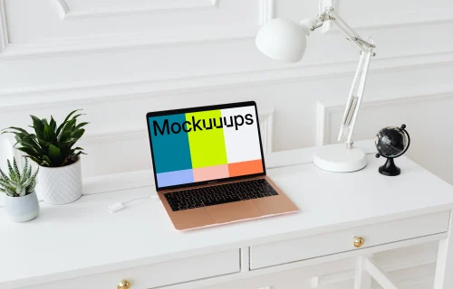 MacBook Air mockup on a table with a globe at the side
