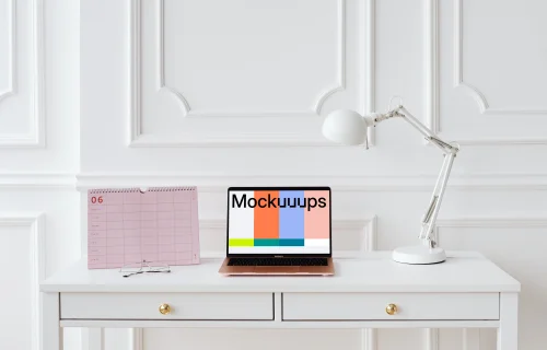 MacBook Air mockup on a table with a pink calendar at the side