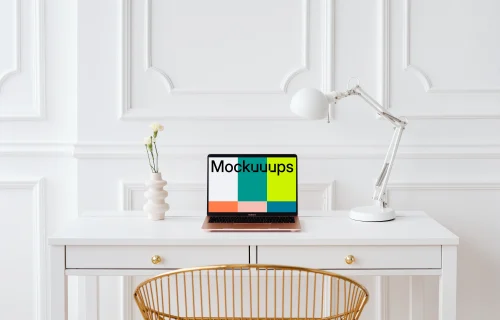 MacBook Air mockup on a table with a plant vase at the side