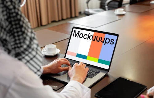 MacBook Air Mockup used by a lady on a conference table