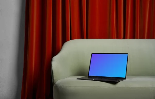 MacBook mockup on a couch with a brown curtain in the background
