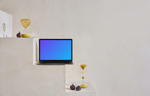 MacBook mockup on a staircase with hourglasses and onions at the side
