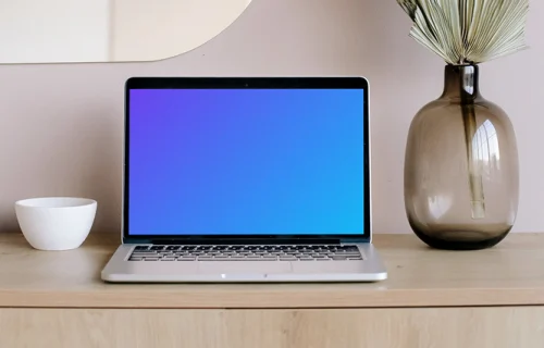 MacBook mockup on a table with mirror in the background