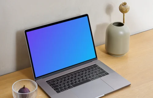 MacBook mockup on a wooden workstation table