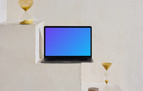 MacBook mockup on staircase with hourglass at the side
