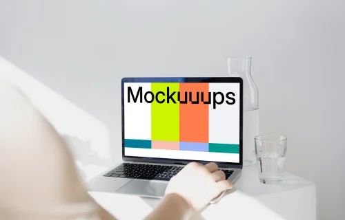 MacBook Pro mockup before a glass jar and tumbler