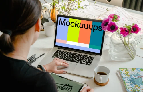 MacBook Pro mockup beside a cup of coffee and nice flowers