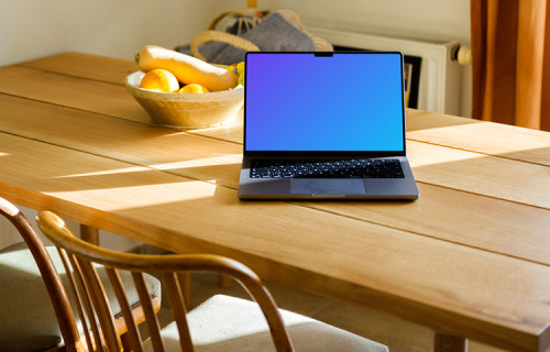 MacBook Pro mockup on a table in front of a fruit basket