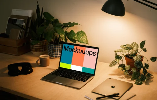 MacBook Pro mockup with a notepad and iPad Air at the side