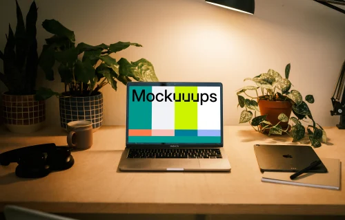 MacBook Pro mockup with a pair of headphones at the side