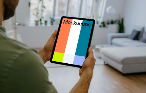 Man holding up an iPad Air mockup