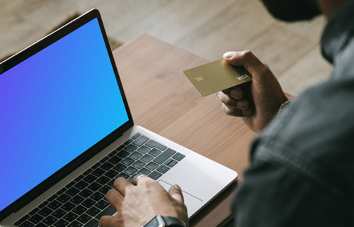 Man making online payment with a Visa card on his MacBook computer mockup.