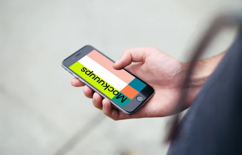 Man standing with iPhone 6s mockup on a street