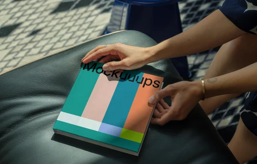 Mockup of a square book on a leather seat