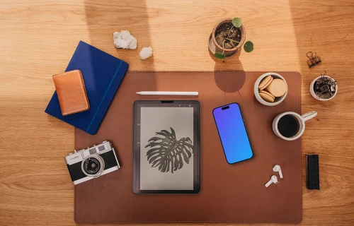 Mockup of phone next to the coffee and tablet