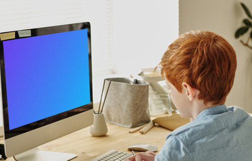 Mockup of red-haired child studying on an iMac