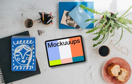 Mockup of tablet device with a plant and coffee on the side