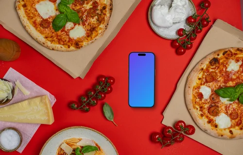 Phone mockup between pizza boxes