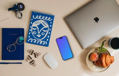 Phone mockup on the desk and laptop on the side