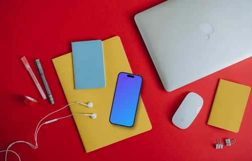 Phone mockup on the red background and laptop on the side
