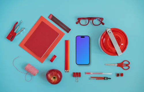Phone mockup with a school equipment around