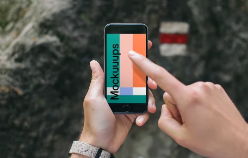 Pointing on iPhone 6 mockup in mountains