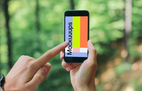 Pointing on iPhone 6 mockup in the forest