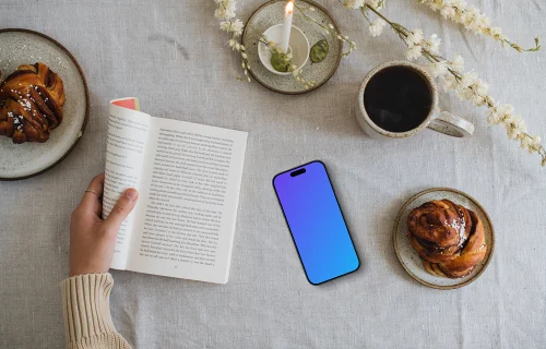 Reading a book with smartphone mockup on the side
