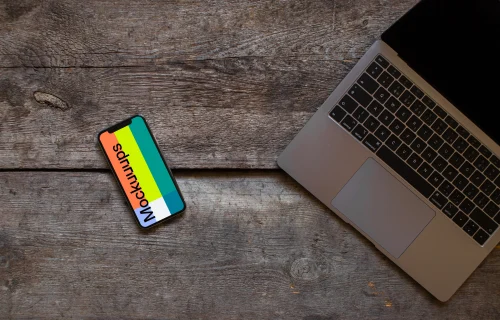 Rotated iPhone XS mockup with Macbook Air on the right side