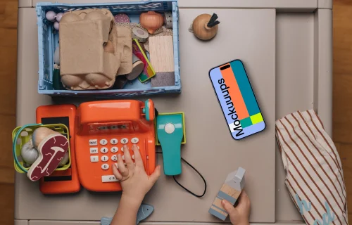 Smartphone mockup amidst children's toys