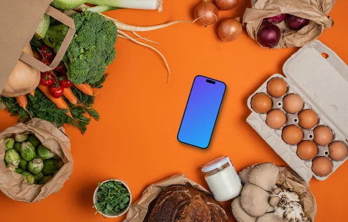 Smartphone mockup between groceries