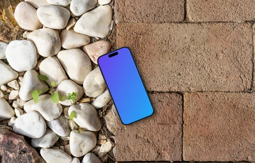 Smartphone mockup laying on a brick path