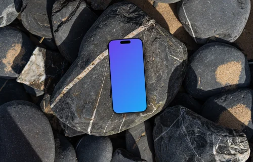 Smartphone mockup laying on a pile of rocks