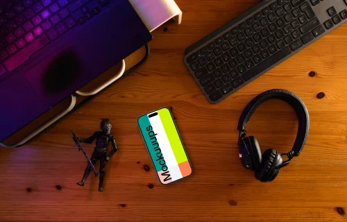 Smartphone mockup on a gamer's desk with action figure