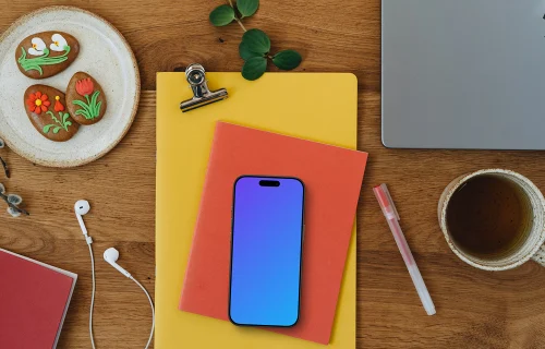 Smartphone mockup on colorful notebooks with Easter gingerbreads