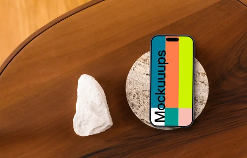 Smartphone mockup on wooden table with stone coaster
